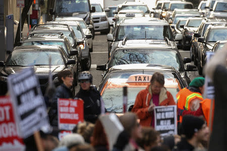 Traffic stalls as protestors stop to block an intersection during a march through downtown Seattle in support of Daniel Ramirez Medina, who was detained by U.S. immigration authorities, in Seattle, Washington, U.S. February 17, 2017. REUTERS/David Ryder