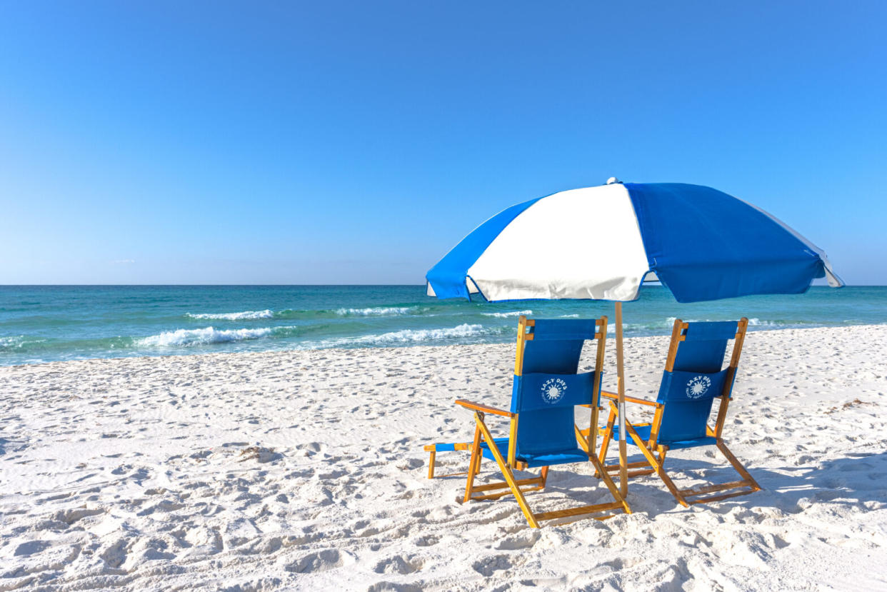 beach chairs with umbrella in the sand