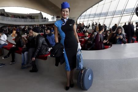 A woman poses inside the Trans World Airlines Flight Center at John F. Kennedy Airport in the Queens borough of New York, October 18, 2015. REUTERS/Shannon Stapleton