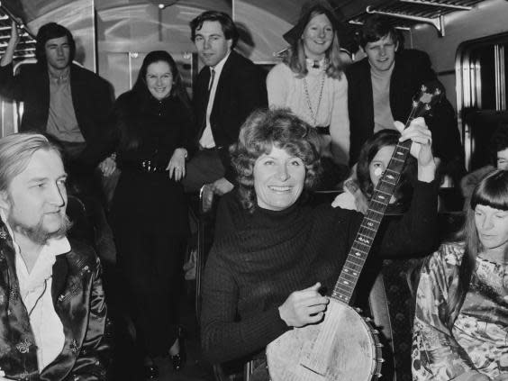Shirley Collins poses with passengers on a train in June 1970 (Getty)