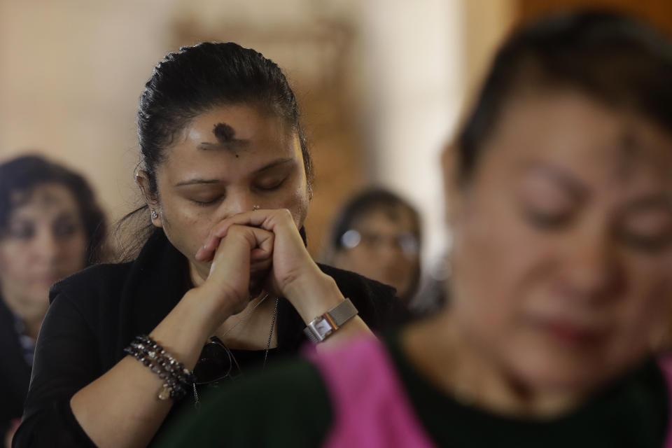 Women listen from their pew during Mass on Ash Wednesday at St. Mary's Cathedral in San Francisco, Wednesday, Feb. 26, 2020. Ash Wednesday for Christians worldwide ushers in a period of penitence and reflection, known as the season of Lent, that leads up to Easter Sunday. (AP Photo/Jeff Chiu)