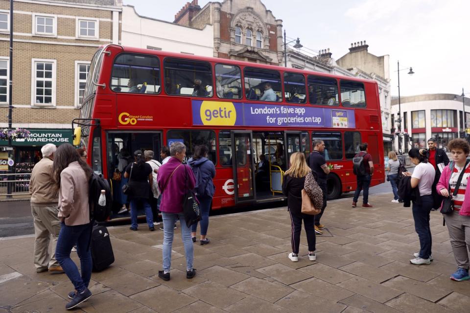 Passengers queue for a bus in Wimbledon amid the rail strike disruption (Steven Paston/PA) (PA Wire)