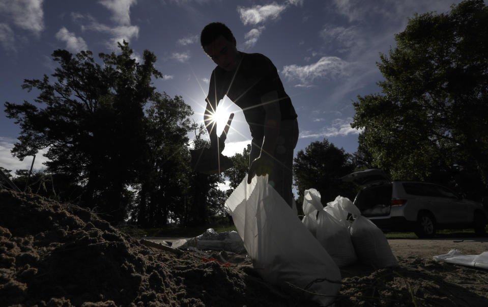 Chase Garces fills sandbags Friday, July 12, 2019, in Baton Rouge, La., ahead of Tropical Storm Barry. Barry could harm the Gulf Coast environment in a number of ways. But scientists say it’s hard to predict how severe the damage will be. (AP Photo/David J. Phillip)