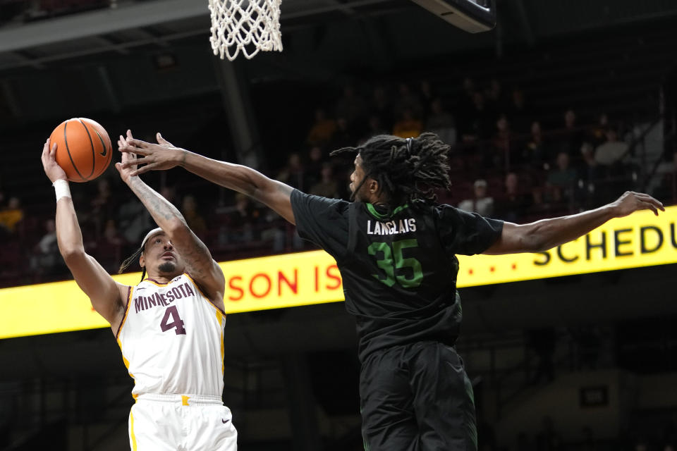 Minnesota guard Braeden Carrington (4) goes up for a shot as USC Upstate forward Ahmir Langlais (35) defends during the first half of an NCAA college basketball game, Saturday, Nov. 18, 2023, in Minneapolis. (AP Photo/Abbie Parr)