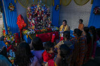 Devotees offer prayers during Durga Puja festival in Gauhati, India, Saturday, Oct. 24, 2020. Weeks after India fully opened up from a harsh lockdown and began to modestly turn a corner by cutting new infections by near half, a Hindu festival season is raising fears that the disease could spoil the hard-won gains. Health experts worry the festivals can set off a whole new cascade of infections, further testing and straining India’s battered health care system. (AP Photo/Anupam Nath)