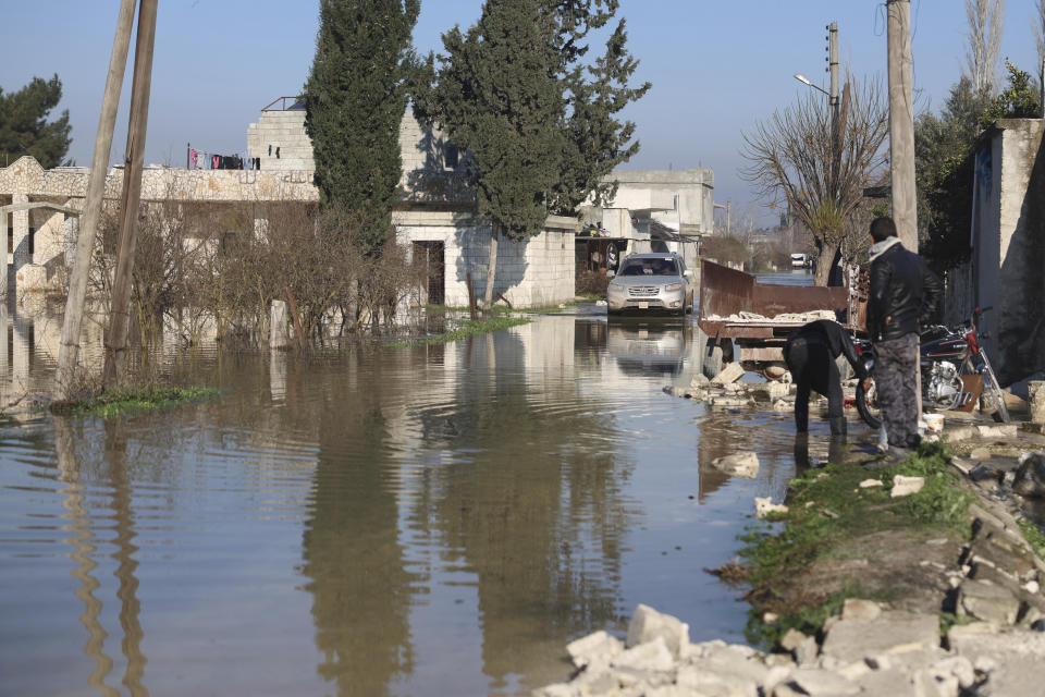 A car drives through the al-Tlul village flooded after a devastating earthquake destroyed a river dam in the town of Salqeen near the Turkish border, Idlib province, Syria, Thursday, Feb. 9, 2023. (AP Photo/Ghaith Alsayed)