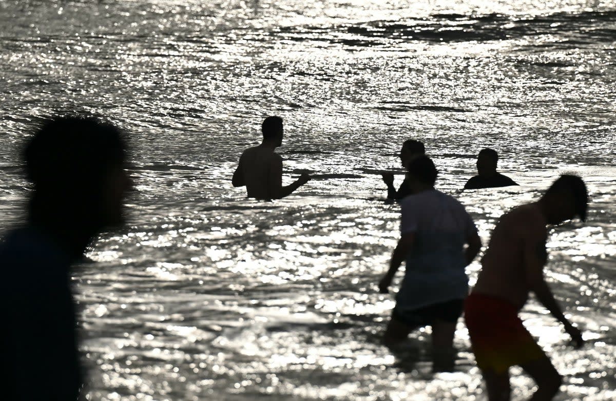 File image: People bathing on the beach. The study says water forecast models, currently in use at over 600 designated bathing locations in the UK, are insufficient to ensure public safety (AFP via Getty Images)