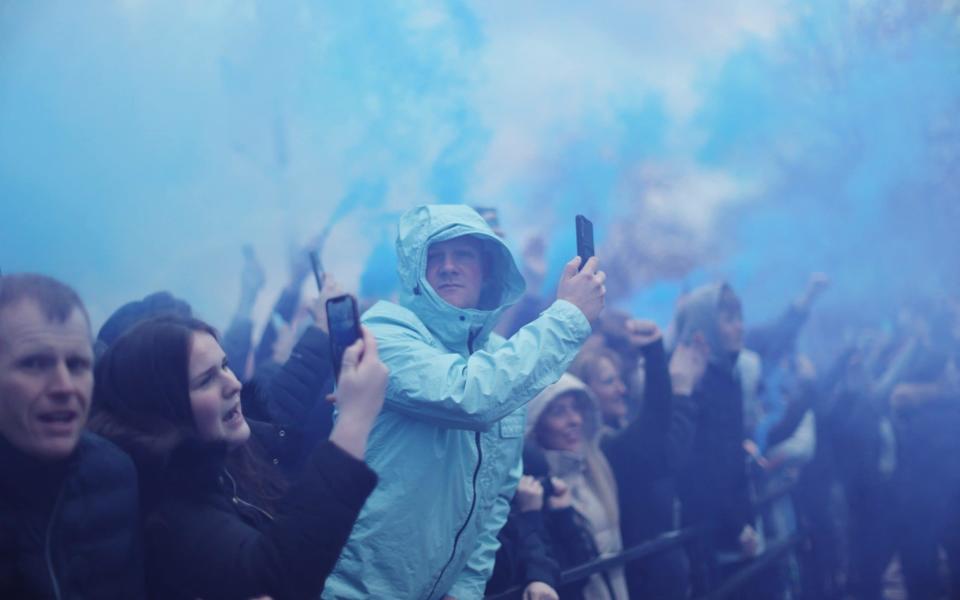 A Manchester City fans amidst smoke from flares before the match  -  Action Images via Reuters/Carl Recine