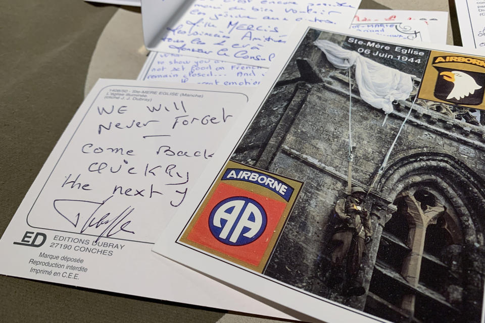 In this Tuesday, Dec. 15, 2020 photo, A handwritten post card from a resident of Sainte-Mere-Eglise, France thanks U.S. paratroopers for liberating their village from Nazi occupation, seen at Fort Bragg, N.C. The town sent 500 notes to Fort Bragg, North Carolina which were read by soldiers. 12,000 82nd paratroopers fought to liberate Normandy on June 6th, 1944. 1,400 were lost their lives in the invasion. (AP Photo/Sarah Blake Morgan)