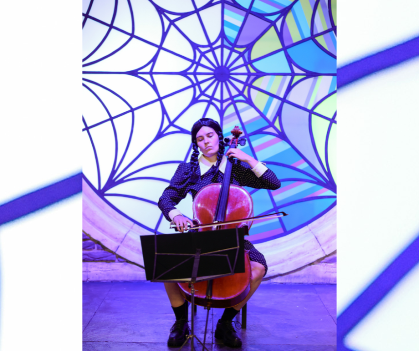 A person dressed as Wednesday Addams plays a cello. (Photo/Andreas Rentz via Getty Images for Netflix)