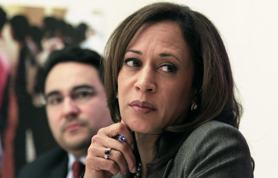 California Attorney General Kamala Harris, right, and Michael Troncoso, Senior Counsel to the Attorney General, left, listen as mortgage fraud victim Jacqueline Marcelos speaks at a roundtable of foreclosure victims at Mission Economic Development Agency in San Francisco, on Monday, Nov. 21, 2011. (AP Photo/Jeff Chiu)