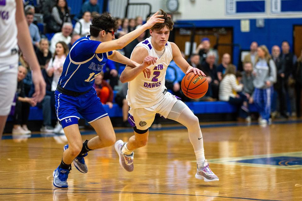 Rumson's David Carr drives against Holmdel's Daxx Corneiro in an NJSIAA Central Group 2 semifinal on Feb. 28, 2024 in Holmdel.