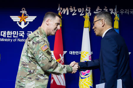 South Korean Defense Ministry's Deputy Minister Yoo Jeh-seung (R) shakes hands with the commander of U.S. Forces Korea's Eighth Army Lieutenant General Thomas Vandal after a news conference about deploying the Terminal High Altitude Area Defense (THAAD) anti-missile system, at the Defense Ministry in Seoul, South Korea, July 8, 2016. You Seung-kwan/News1 via REUTERS