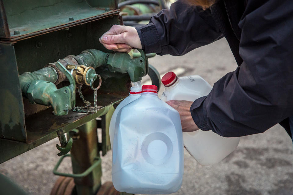 Local residents brought empty containers and coolers to distribution centers across Kanawha County (W.Va.) Sunday morning, Jan. 12, 2014 to fill with water after a chemical spill Thursday in the Elk River that has contaminated the public water supply in nine counties. Frustration is mounting for many of the 300,000 West Virginia residents who've gone three days without clean tap water. (AP Photo/Michael Switzer)