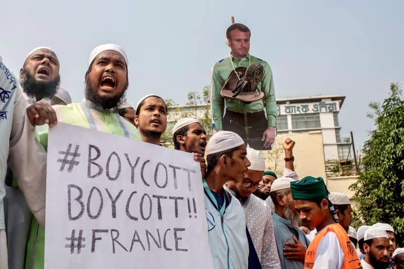 Supporters and activists of the Islami Andolan Bangladesh take part in a protest calling for the boycott of French products and to denounce the French President Emmanuel Macron for his comments over a cartoon of Prophet Mohammad in Dhaka