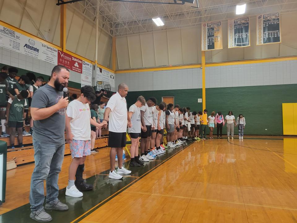 A prayer is offered Saturday at Central Lafourche High's basketball scrimmage for Raceland resident Everette Jackson, 21, who was missing after falling into a river a week earlier during a rafting trip in Idaho. From left are Antonio Nieves, Micah Nieves, coach Henry  Latten and members of the school's boys basketball team.