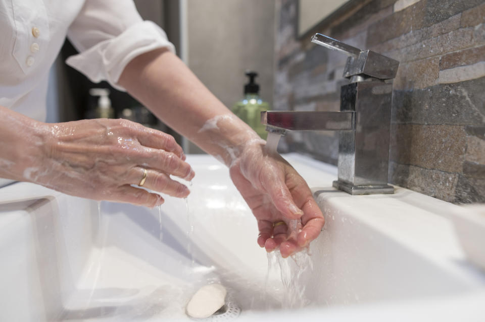 If you don't have a separate bathroom your sick partner can use, keep disinfecting wipes in your shared bathroom and wipe all communal surfaces down after use. (Photo: F.J. Jimenez via Getty Images)