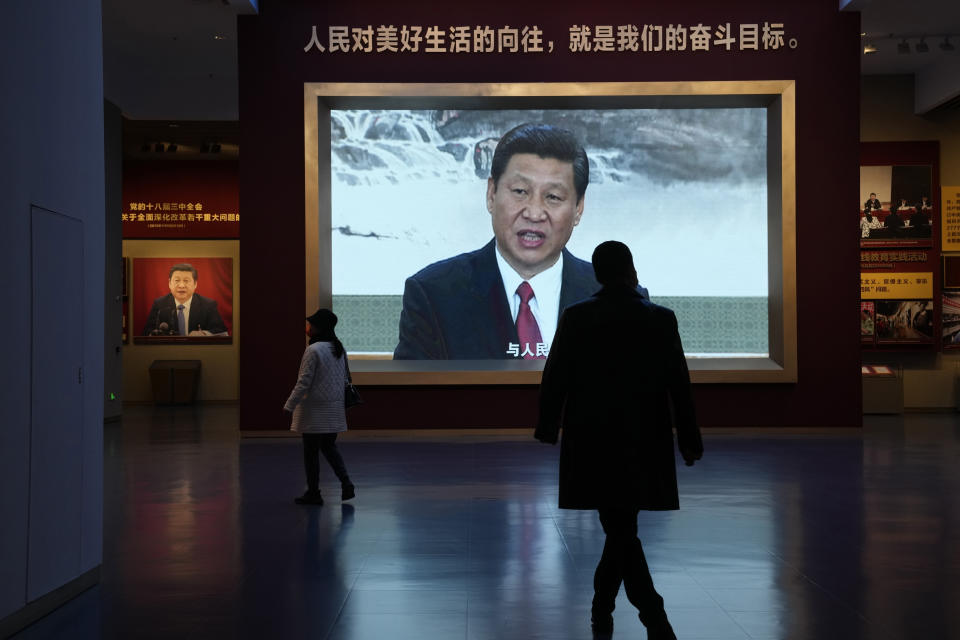 Chinese President Xi Jinping is seen on screen near the slogan "The people's yearning for a better life is the goal we strive for" at the Museum of the Communist Party of China here in Beijing, China, Friday, Nov. 12, 2021. Xi emerges from a party conclave this week not only more firmly ensconced in power than ever, but also with a stronger ideological and theoretical grasp on the ruling Communist Party's past, present and future. (AP Photo/Ng Han Guan)