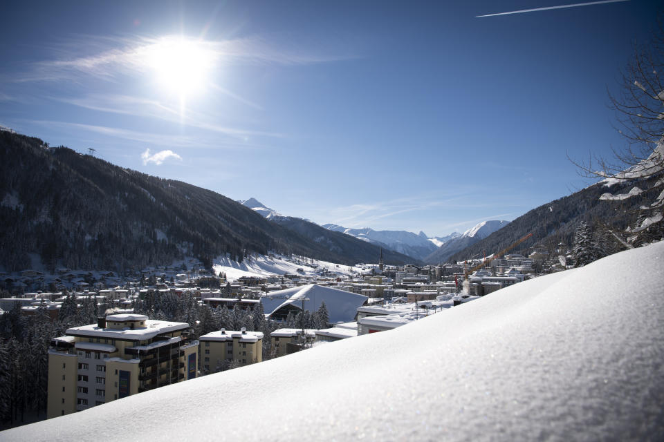 The sun shines as buildings are covered with snow in Davos, Switzerland, Tuesday, Jan. 15, 2019. The World Economic Forum will take place in Davos from Jan. 22, 2019 until Jan. 25, 2019. (Gian Ehrenzeller/Keystone via AP)