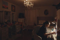 Gabriela Durham, 17, uses her phone to listen to music inside her room on Saturday, Jan. 27, 2024, in New York. With the damaging consequences of social media increasingly well documented, many parents are trying to raise their children with restrictions or blanket bans. Teenagers themselves are aware that too much social media is bad for them, and some are initiating social media “cleanses” because of the toll it takes on mental health and grades. (AP Photo/Andres Kudacki)