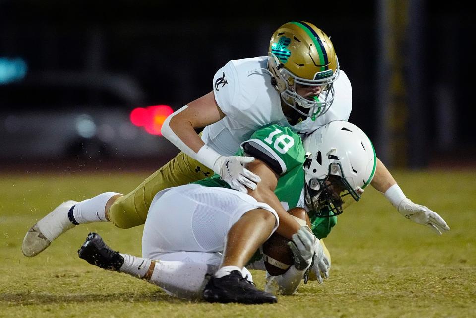 November 11, 2022; Phoenix, Ariz; USA; Yuma Catholic linebacker Dagen Dunn (12) tackles St. Marys Andrue Cannon (18) during a game at Hoy Stadium. Mandatory Credit: Patrick Breen-Arizona Republic