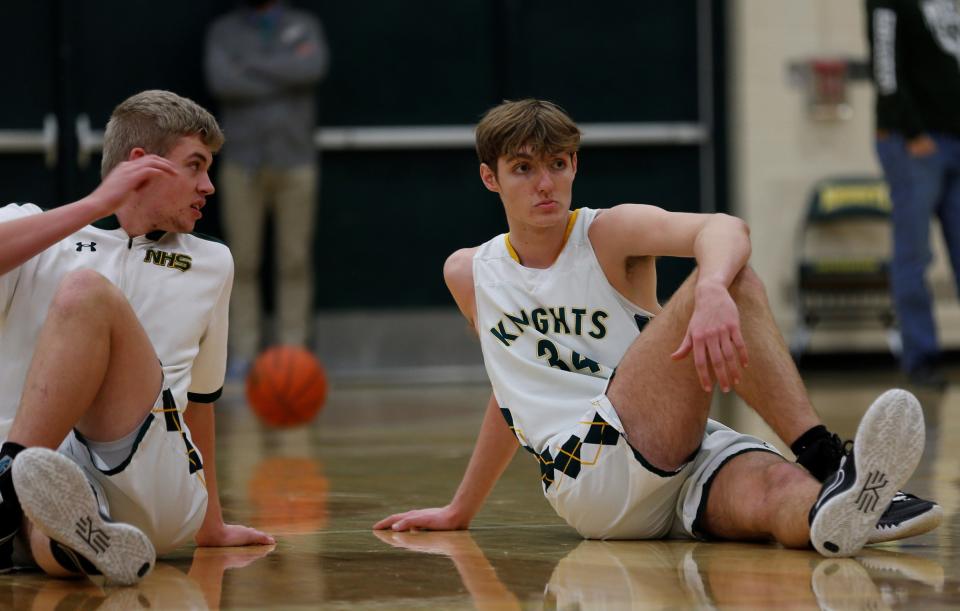 Northeastern seniors Payton Lumpkin (left) and Raedhyn Foust (right) stretch during warmups before a game against Rushville Jan. 21. 2022.