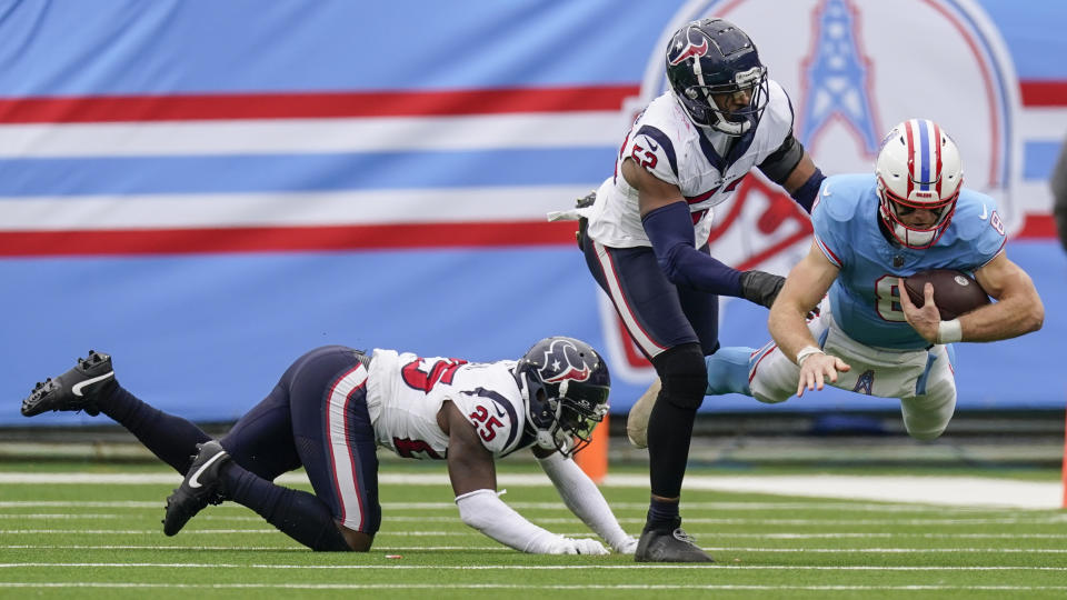 Tennessee Titans quarterback Will Levis (8) dives after a run against Houston Texans defensive end Jonathan Greenard (52) during the first half of an NFL football game, Sunday, Dec. 17, 2023, in Nashville, Tenn. (AP Photo/George Walker IV)