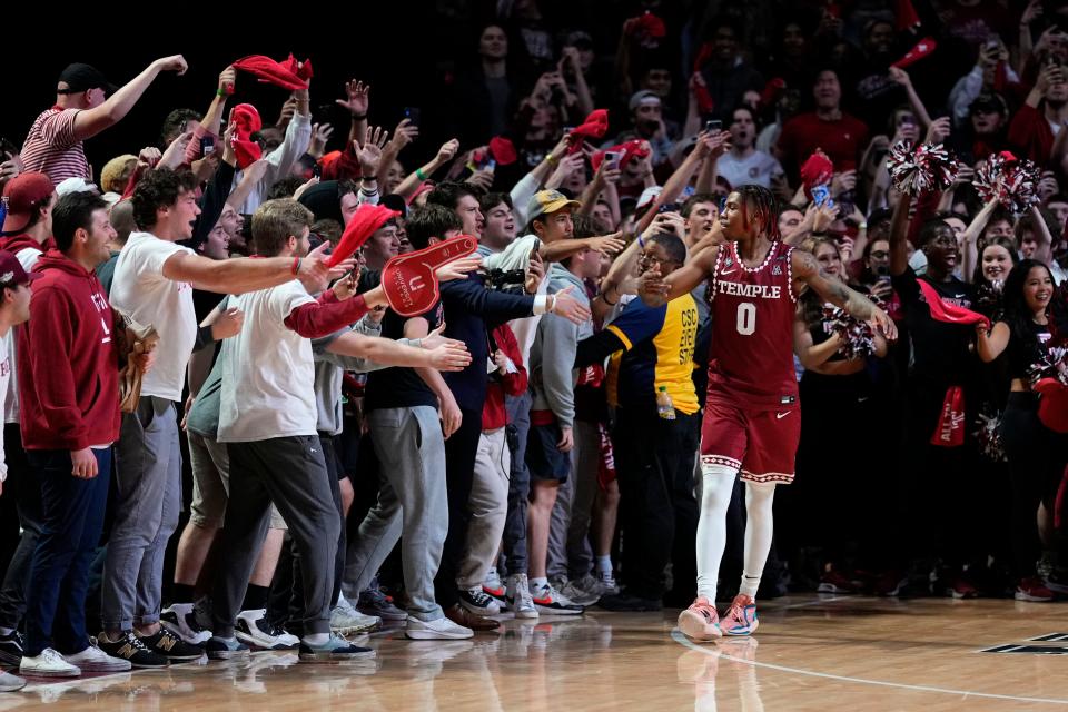 Temple's Khalif Battle celebrates with fans in the final seconds of their early season win against Villanova.