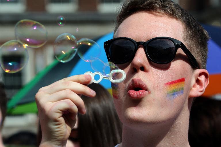 A man blows bubbles as supporters for same-sex marriage gather at Dublin Castle on May 23, 2015 in Dublin