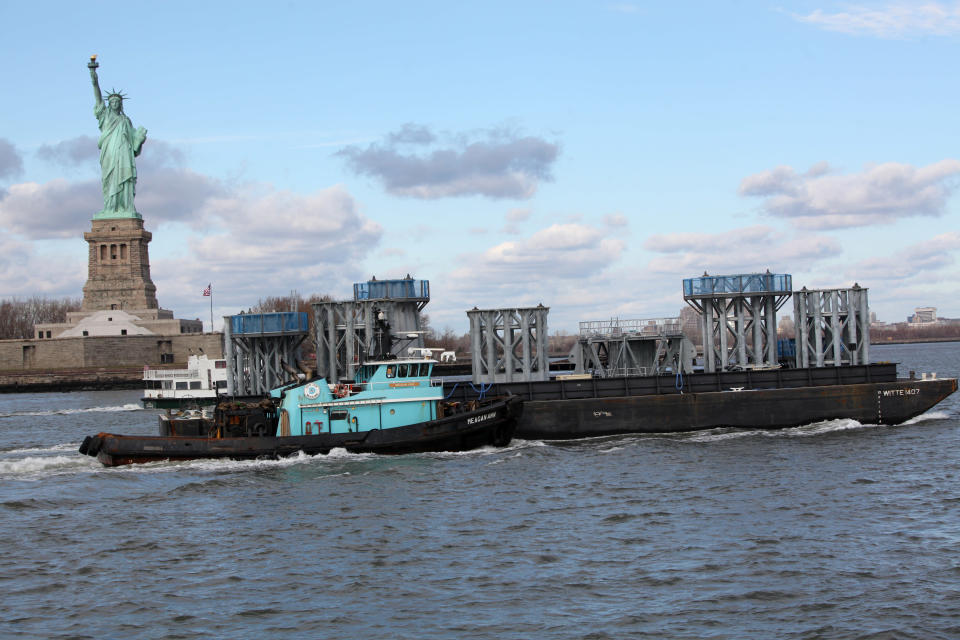 Parts of the spire for the Freedom Tower make their way on a barge from Port Newark to lower Manhattan where they will be unloaded and installed on top of the Freedom Tower starting tomorrow on December 11, 2012 in New York City. The barge is carrying nine pieces of steel that will eventually top off One World Trade Center at a symbolic 1,776 feet, becoming the tallest building in the Western Hemisphere. (Photo by Chris Pedota-Pool/Getty Images)