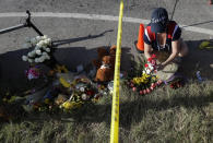 <p>Rebecca Thompson places flowers at a makeshift memorial near the scene of a shooting at the First Baptist Church of Sutherland Springs to honor victims, Monday, Nov. 6, 2017, in Sutherland Springs, Texas. (Photo: Eric Gay/AP) </p>