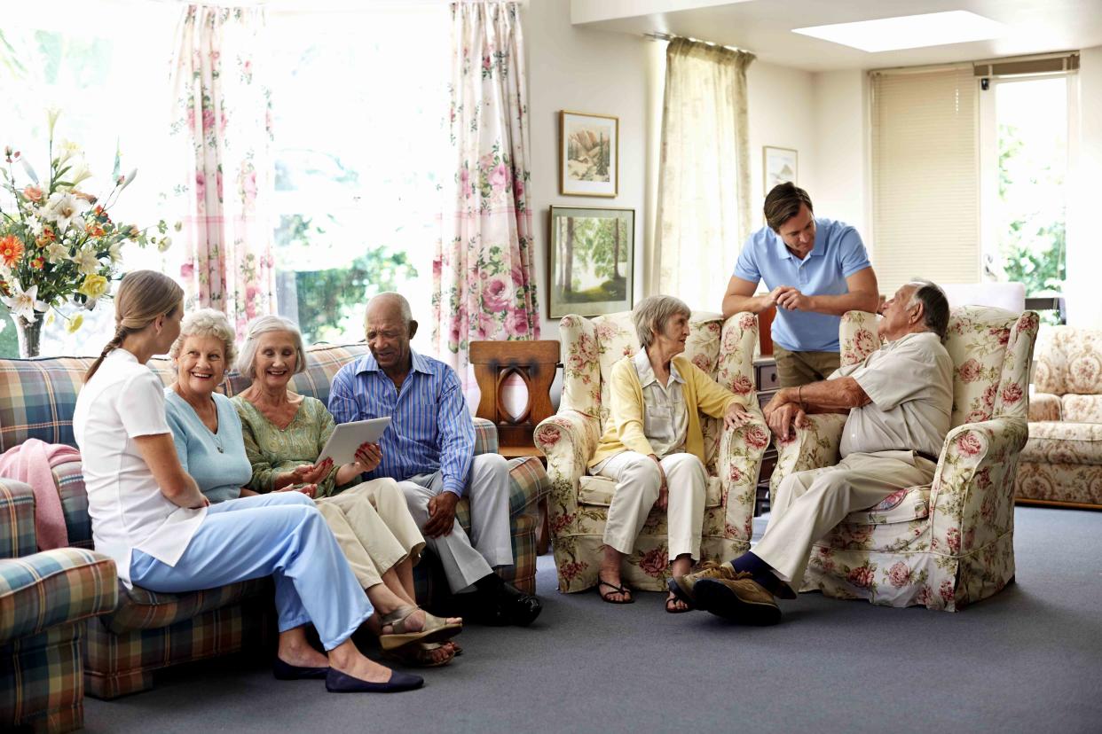 Morsa Images / Getty Images Stock image of caretakers with retired people at a nursing home