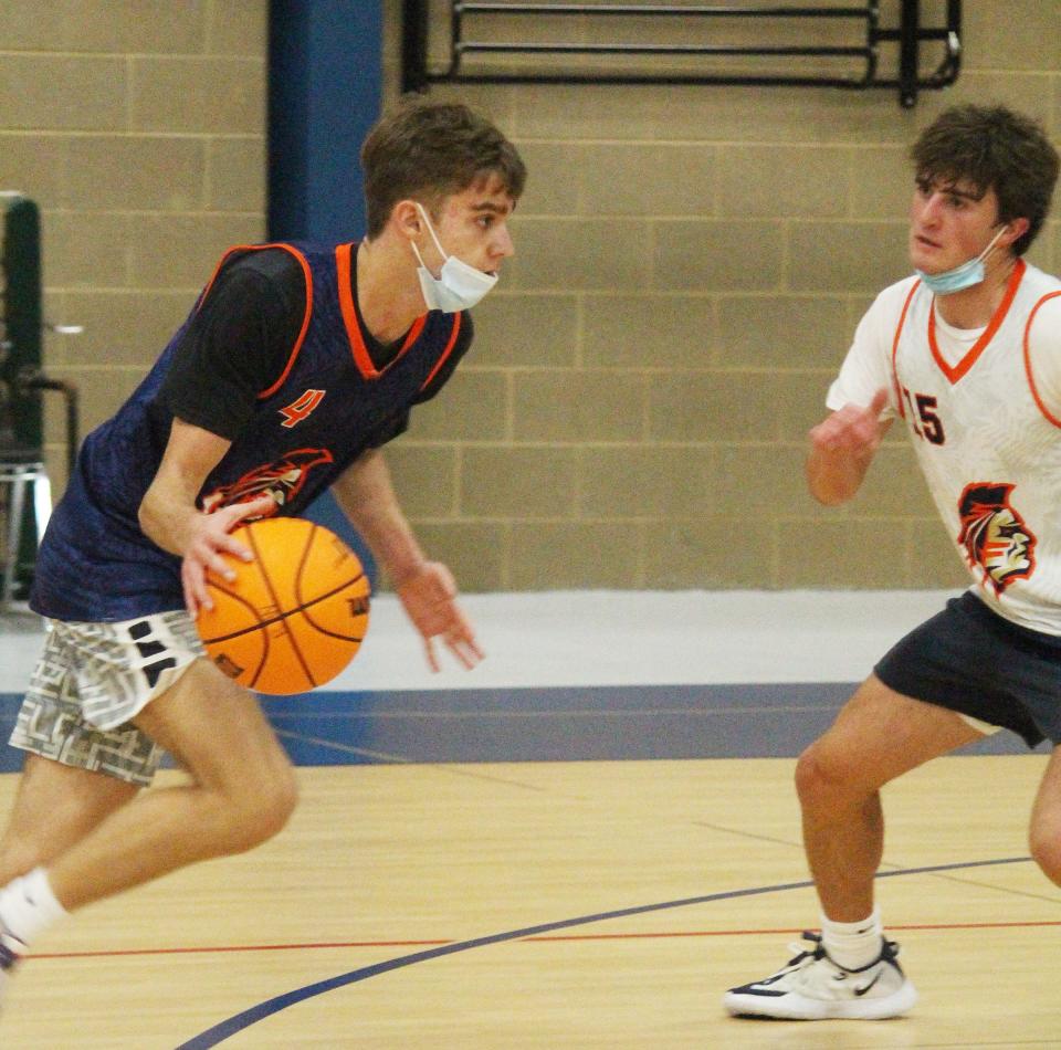 Pontiac sophomore Kerr Bauman drives against classmate Michael Kuska during boys' basketball practice at the Rec-Center Tuesday. The Indians will open their varsity season Nov. 22 at the Dean Riley Tournament in Ottawa.