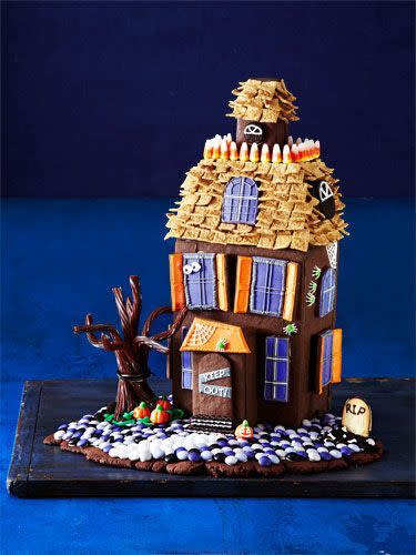 <p>Decorate this haunted cookie mansion with candy corn and Golden Grahams cereal. </p><p>Get the <strong><a href="https://www.womansday.com/food-recipes/food-drinks/g1658/halloween-haunted-cookie-house/" rel="nofollow noopener" target="_blank" data-ylk="slk:Halloween Haunted House recipe;elm:context_link;itc:0;sec:content-canvas" class="link ">Halloween Haunted House recipe</a></strong>.</p>