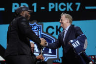 Alabama offensive lineman JC Latham celebrates with NFL Commissioner Roger Goodell, right, after being chosen by the Tennessee Titans with the seventh overall pick during the first round of the NFL football draft, Thursday, April 25, 2024, in Detroit. (AP Photo/Jeff Roberson)