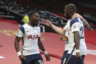 Tottenham's Serge Aurier, left, celebrates after scoring his side's fifth goal during the English Premier League soccer match between Manchester United and Tottenham Hotspur at Old Trafford in Manchester, England, Sunday, Oct. 4, 2020. (Carl Recine/Pool via AP)