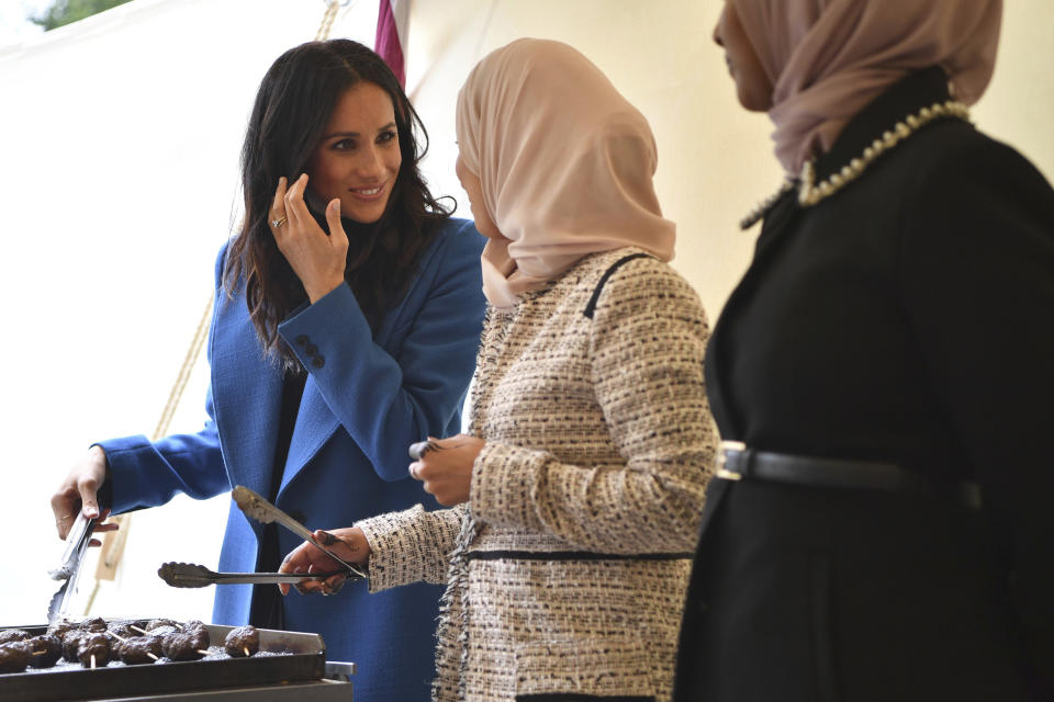 Meghan, the Duchess of Sussex, left, cooks with women involved in the cookbook "Together" during a reception at Kensington Palace, in London, Thursday Sept. 20, 2018. Markle was joined by her mother Doria Ragland and husband Prince Harry for the launch of a cookbook aimed at raising money for victims of the Grenfell fire. (Ben Stansall/Pool Photo via AP)