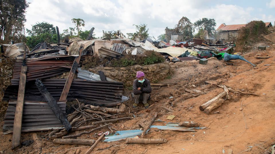 A man sits in front of a house that was destroyed by an air strike in Shan state, Myanmar on December 14, 2022. - Mai Thomas/SOPA Images/LightRocket/Getty Images/File