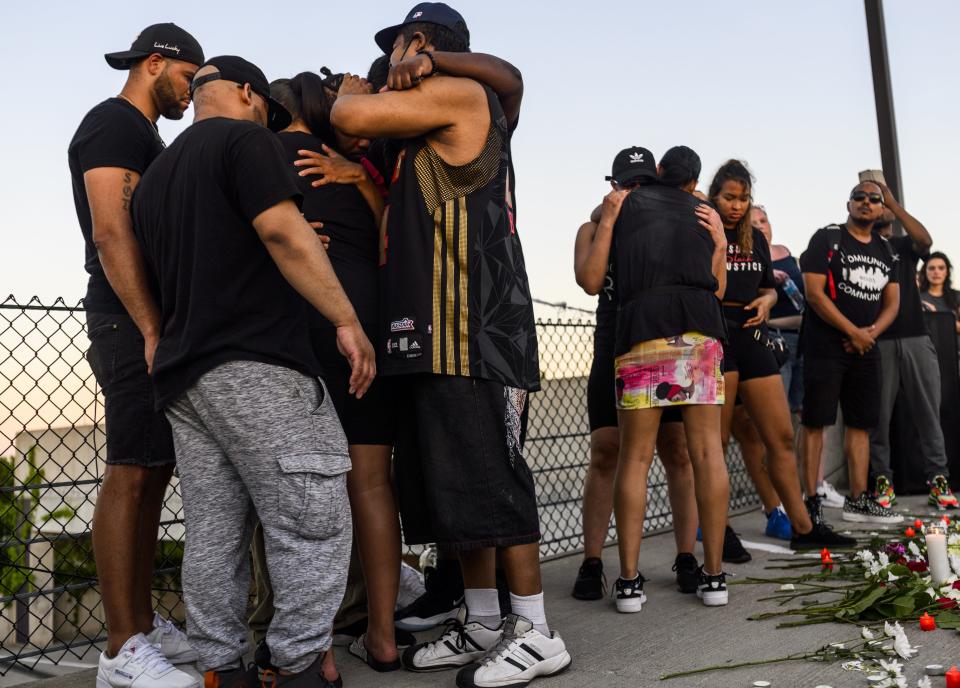 Friends and family embrace during a vigil at the site where Winston Boogie Smith was killed on June 4, 2021 in Minneapolis, Minnesota. Smith was shot and killed yesterday during an altercation with law enforcement involving multiple agencies. Smith's family is demanding clarity in the case as authorities claim there is no video available from the incident.