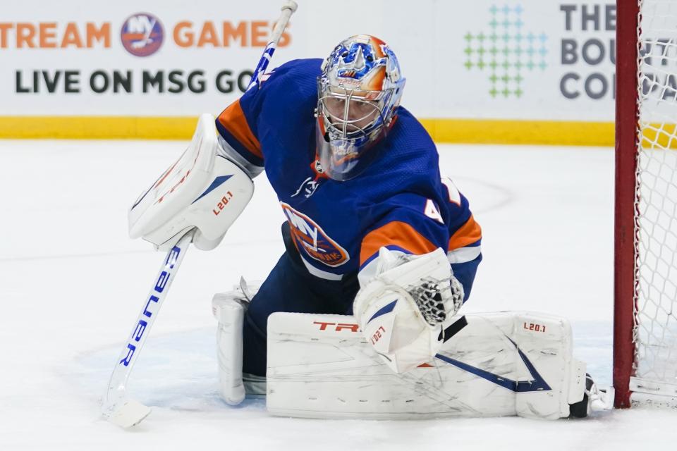 New York Islanders goaltender Semyon Varlamov stops a shot during the third period of the team's NHL hockey game against the New York Rangers on Tuesday, April 20, 2021, in Uniondale, N.Y. The Islanders won 6-1. (AP Photo/Frank Franklin II)