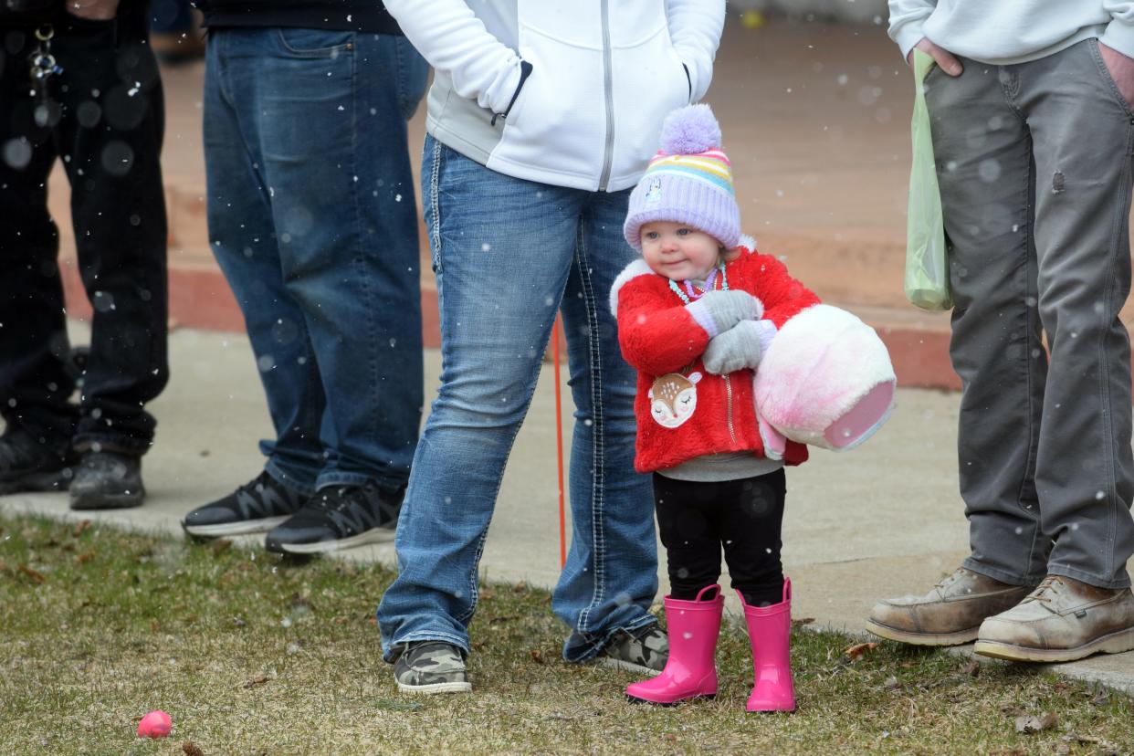Ellie McMullen, 1 1/2, prepares to grab eggs as she waits for the Egg Scramble to start on Saturday, April 8 at the Emmet County Fairgrounds in Petoskey.