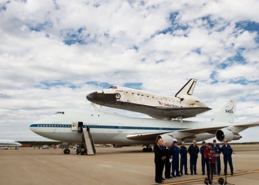 Officials and the crew of the 747 that carried the Space Shuttle Discovery to its retirement home outside Washington speak to reporters