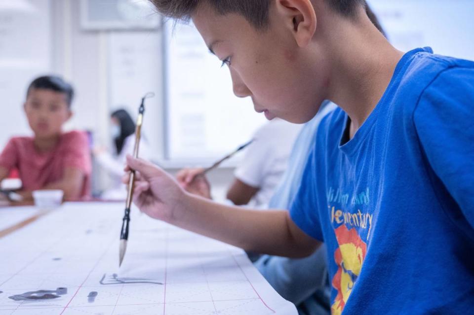 Kingston Lui, 10, a student at the summer school program at William Land Elementary in Southside Park, practices writing a Chinese character during the Mandarin immersion program on Tuesday, July 11, 2023. The school’s Mandarin immersion program is one of seven dual language immersion programs in the Sacramento City Unified School District.