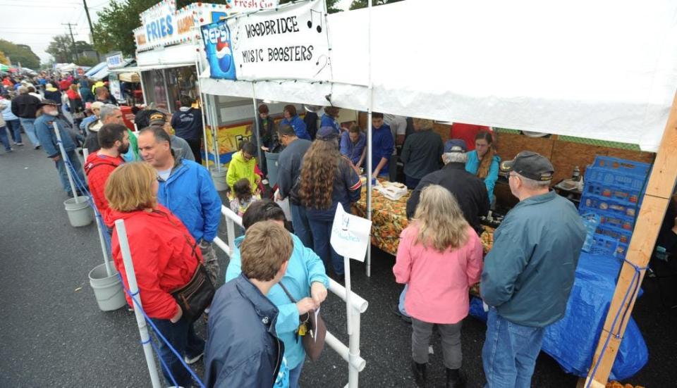 Apple Scrapple festival-goers wait in line for a scrapple sandwich.