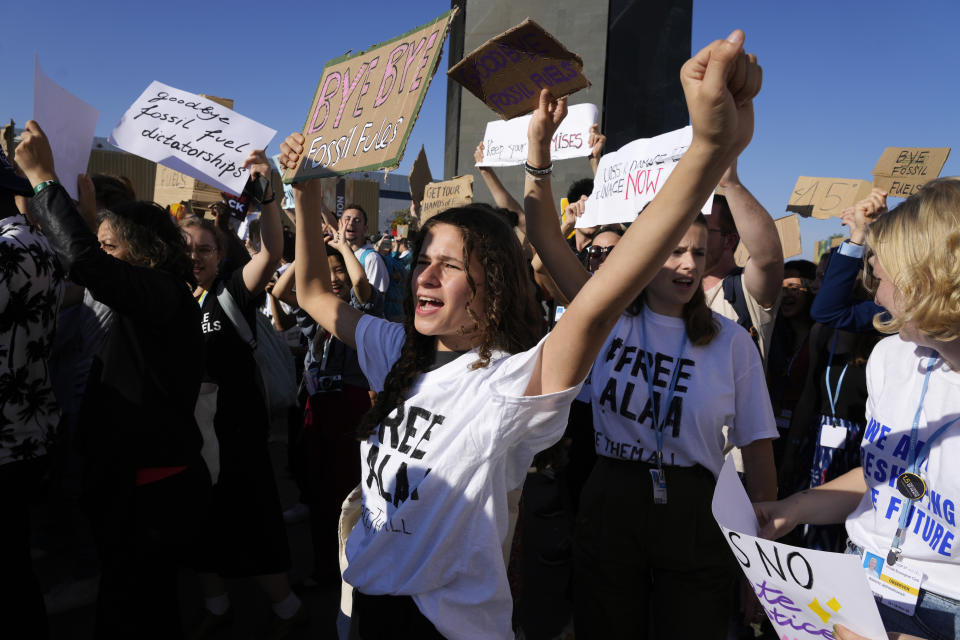 FILE - Demonstrators participate in a protest against fossil fuels at the COP27 U.N. Climate Summit, Friday, Nov. 18, 2022, in Sharm el-Sheikh, Egypt. U.S. climate envoy John Kerry said the international global warming talks didn’t do enough to speed up cuts in emissions of heat-trapping gases. (AP Photo/Peter Dejong, File)