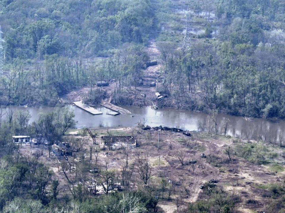 In this handout photo provided by the Ukraine Armed Forces on Thursday, May 12, 2022, a ruined pontoon crossing with dozens of destroyed or damaged Russian armored vehicles on both banks of Siverskyi Donets River after their pontoon bridges were blown up in eastern Ukraine. (Ukrainian Presidential Press Office via AP)