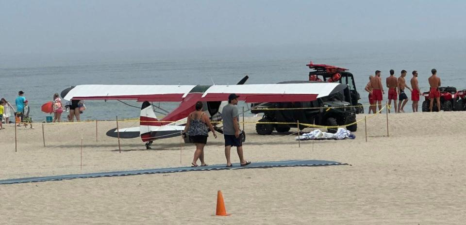 A small plane is seen on Hampton Beach after crash landing in the water about 30 yards off shore Saturday, July 29, 2023.