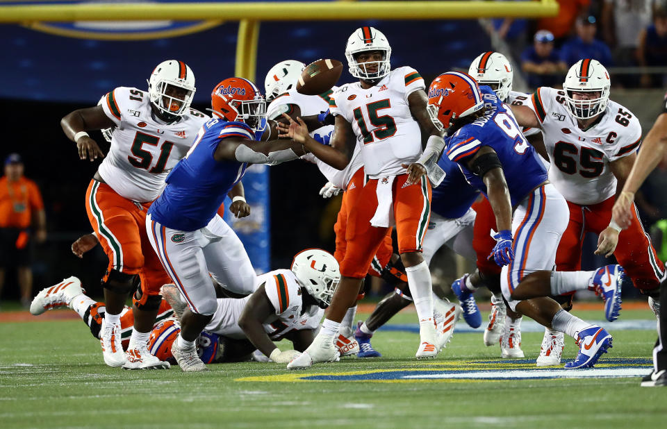 Florida Gators defensive lineman Zachary Carter (17) pressures Miami Hurricanes quarterback Jarren Williams (15) during the second half at Camping World Stadium. (USAT)