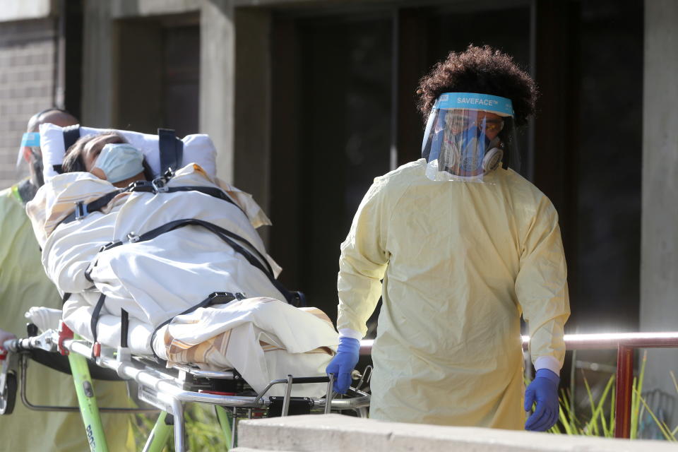 Employees of a stretcher service wear personal protective gear as they return a resident to Parkview Place personal care home, which is experiencing an outbreak of the coronavirus disease (COVID-19), in Winnipeg, Manitoba, Canada, November 2, 2020.  REUTERS/Shannon VanRaes     TPX IMAGES OF THE DAY