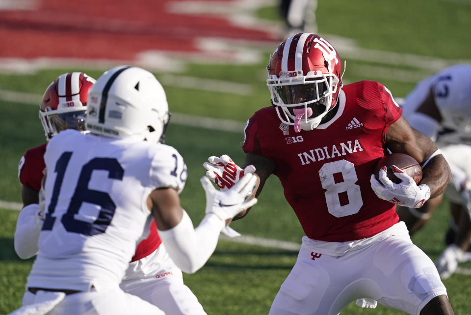 Indiana running back Stevie Scott III (8) runs against Penn State's Ji'Ayir Brown (16) during the first half of an NCCAA college football game, Saturday, Oct. 24, 2020, in Bloomington, Ind. (AP Photo/Darron Cummings)